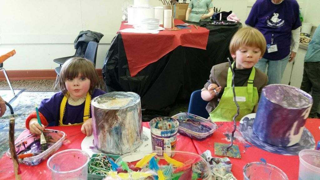 Two children making art with paint at the AbraCadabra workshop