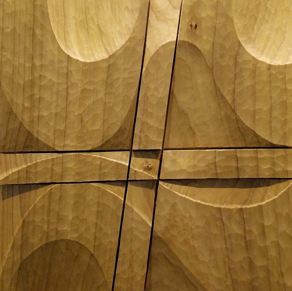 A dimensional wood sculpture with sanded curves and sharp cuts, by Monica Setziol-Phillips