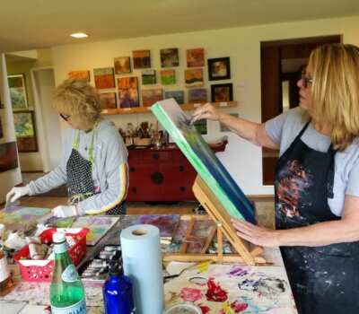 Lynne Wintermute working in their studio on a painting